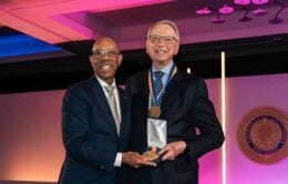 President Drake handing Irwin Jacobs an award