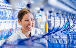 Smiling female graduate student working in a lab