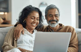 Adult couple at home looking at a laptop together