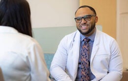 Nurse practitioner Chris Hall speaks with a patient