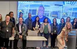 Group of people standing together at the front of a room