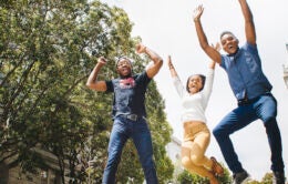 People jumping in the air and cheering