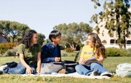 UC Irvine students sitting on a lawn
