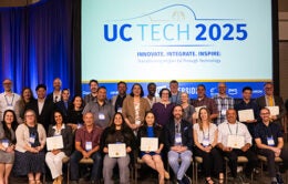 Group of people sitting together holding certificates