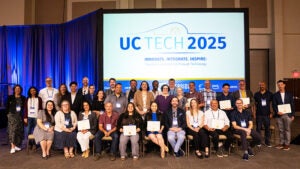 Group of people sitting together holding certificates