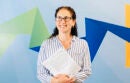Smiling woman holding paperwork