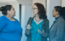 Three staff members talking