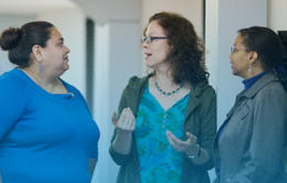 Three staff members talking