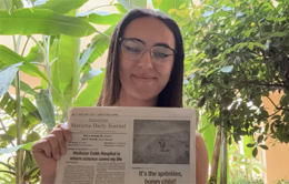 UCLA student reading a newspaper editorial