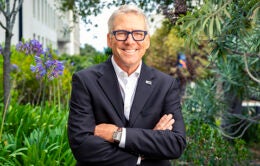 Smiling President James B. Milliken outside in a garden