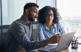Two people working at a computer