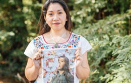 Woman holding up an embroidered print