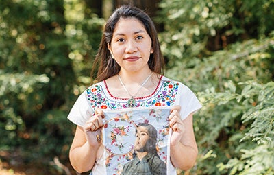 Woman holding up an embroidered print