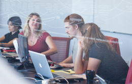 People having a discussion while working on laptops