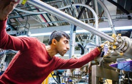 Person inspecting large and complicated machinery