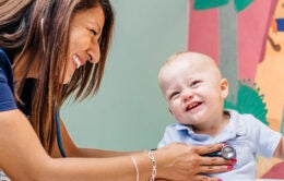 A pediatric cardiologist interacting with a baby
