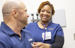 A UC Davis Health nurse examines a colleague
