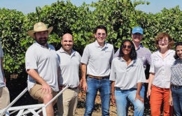 Group of people standing in an orchard