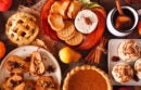 Autumn food concept. Selection of pies, appetizers and desserts. Top view table scene over a rustic wood background.