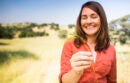 Happy woman holding a piece of straw