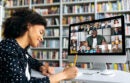 African American happy female student, learning distantly, watches an online lecture, taking notes, multiracial smiling people on a computer screen, virtual communication