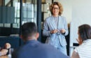 Mature business woman having a discussion with her team.