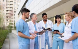 Medical students chatting outside a hospital