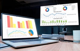 Chart presentation on a display television and laptop in meeting room
