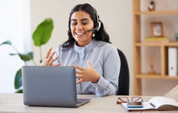 Woman participating in a webinar wearing headphones