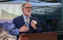 Steve Monfort speaking at a podium