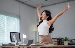 Woman stretching at her desk