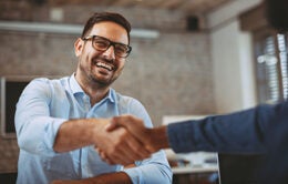 Man shaking hands with someone in the office