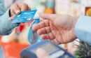 Person paying a cashier with a credit card