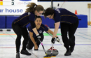 Women curling at an ice rink