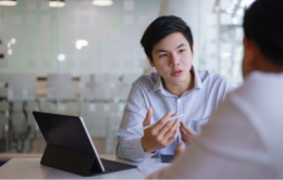 Man having a conversation with his manager in an office