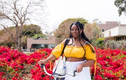 UC Riverside student standing near blooming bougainvillia