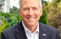 Smiling President James B. Milliken outside in a garden