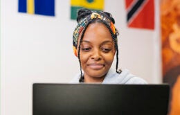 Yasmine Khiar, 4th year film maker and student worker at the African Student Programs Center, working on her computer