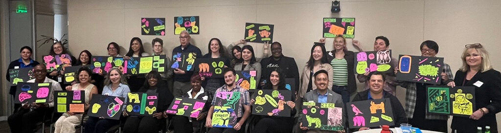 Group of people holding colorful papers