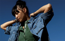Woman adjusting her jean jacket