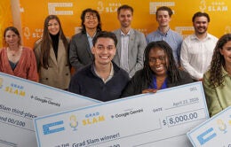 Grad Slam participants and winners posing with giant ceremonial checks