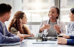 Woman leading group conversation during meeting