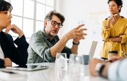 Business man explaining a project to his team.