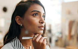 Woman contemplating what she wants to write