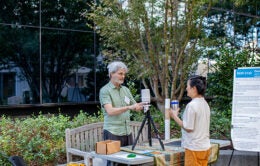 A UC scientist shares his research with a UCOP staff member