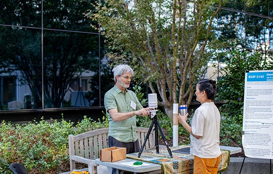 A UC scientist shares his research with a UCOP staff member