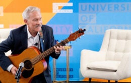 Chancellor Lyons performing acoustic guitar in Oakland