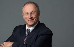 Ralph J. Hexter headshot against gray background
