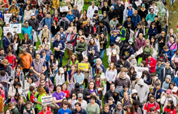 Large group of people outdoors with signs