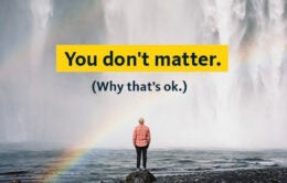 "You don't matter. (Why that's ok.)" Man standing in front of a waterfall under a rainbow